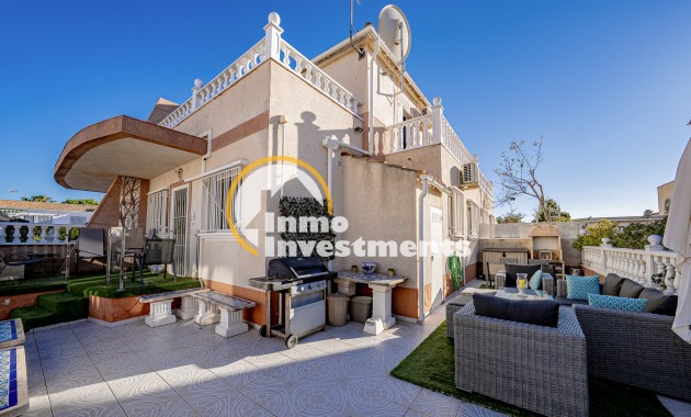 Quad house exterior in Cabo Roig with tiled courtyard, awnings, balustrade terrace and satellite dish