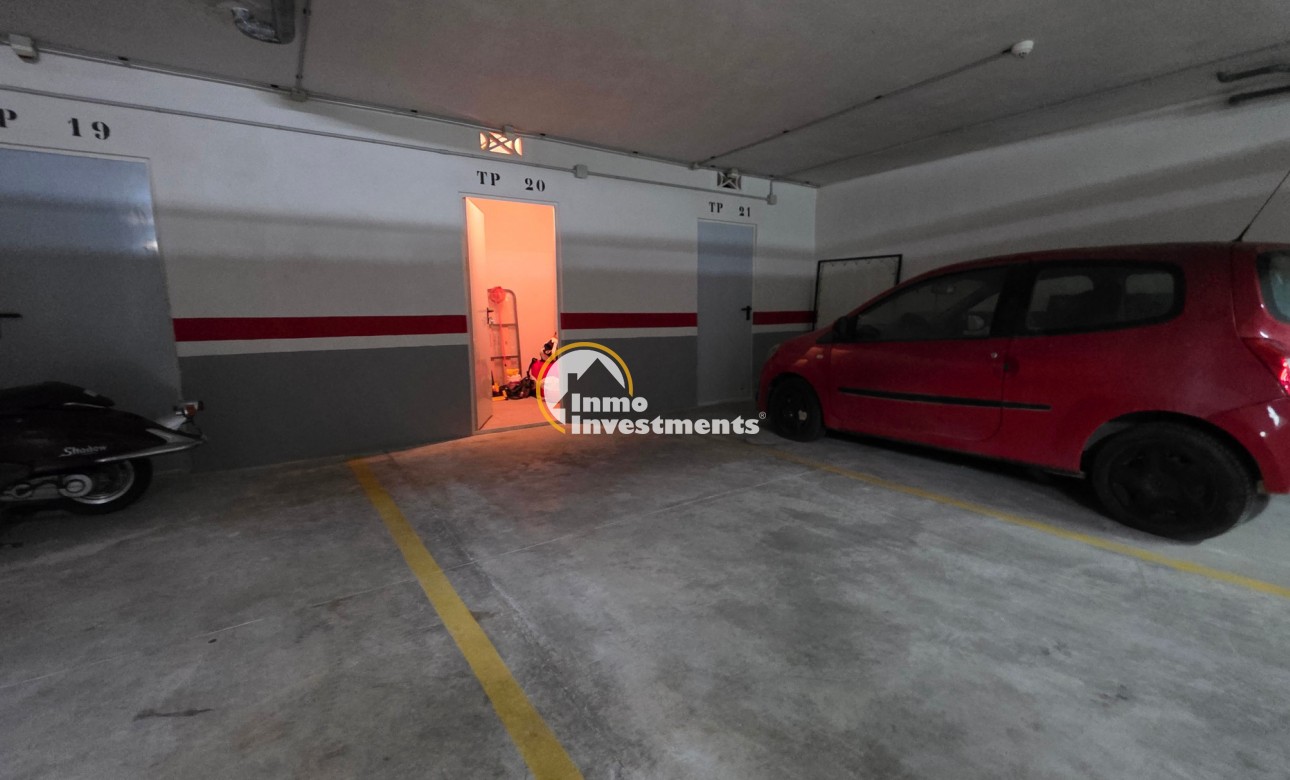 Underground garage parking spaces with storage doors for Mil Palmeras apartment