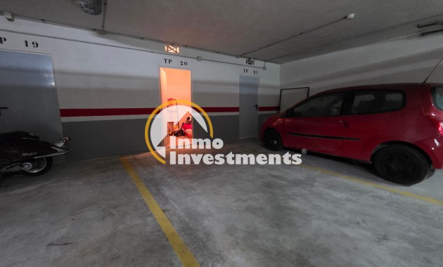 Underground garage parking spaces with storage doors for Mil Palmeras apartment